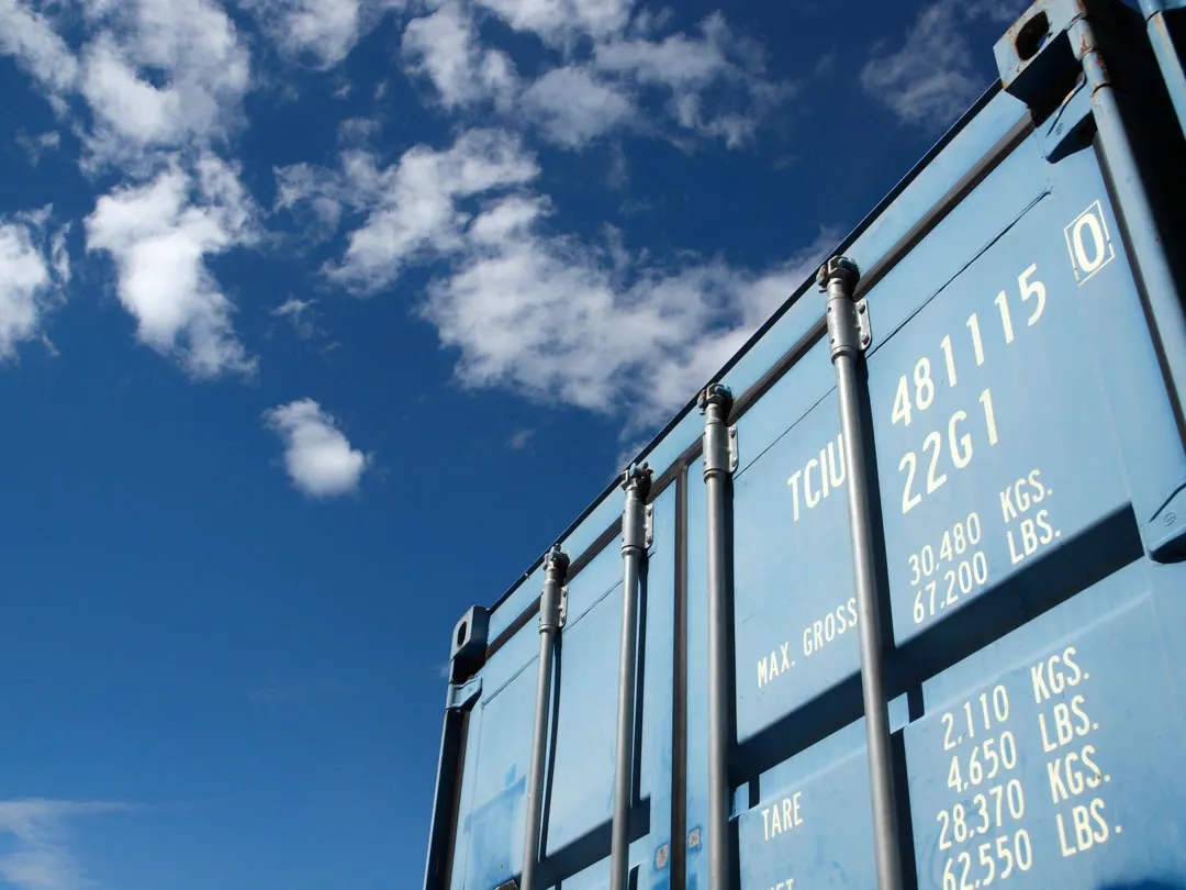 A blue shipping container against the sky
