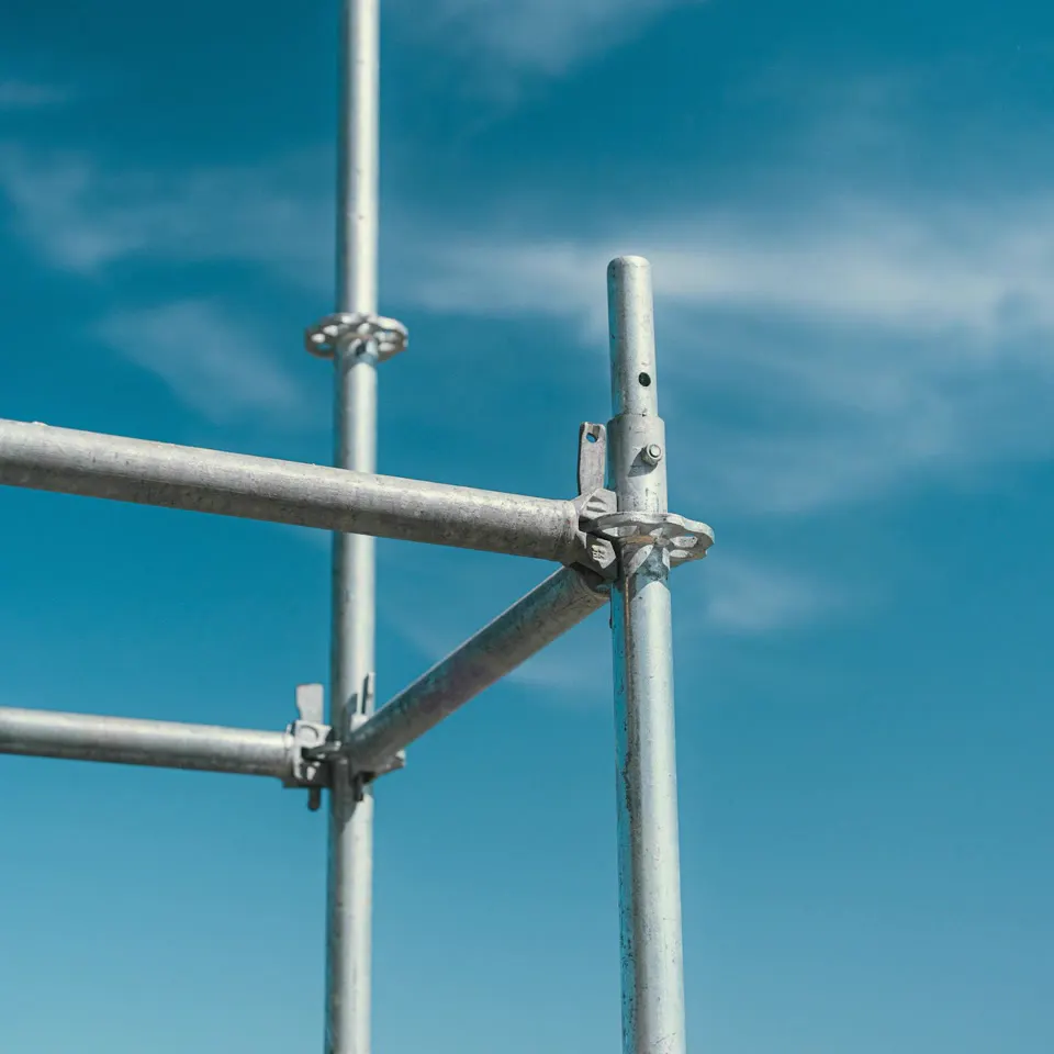 Bare scaffolding poles against the sky