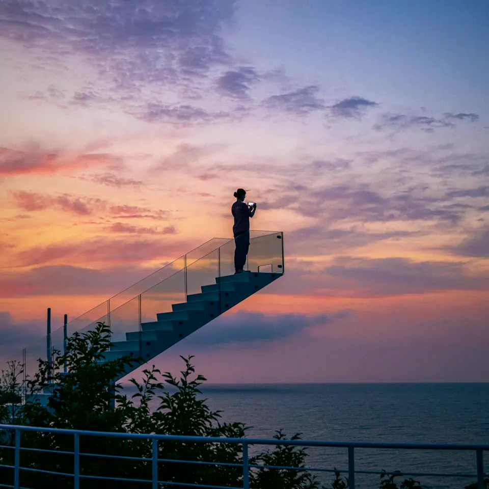 A stairway that ends in the air at dusk